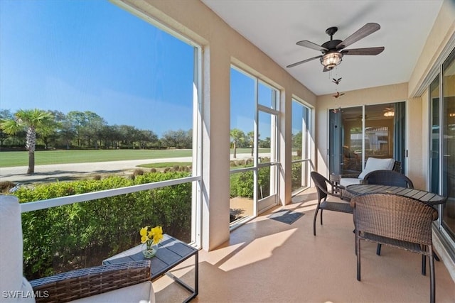 sunroom featuring ceiling fan