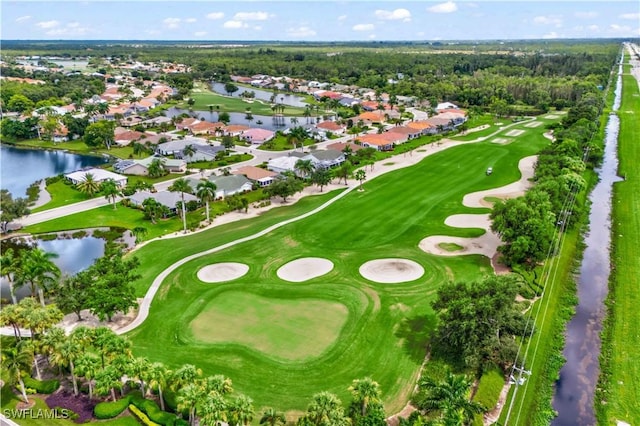 aerial view featuring view of golf course and a water view