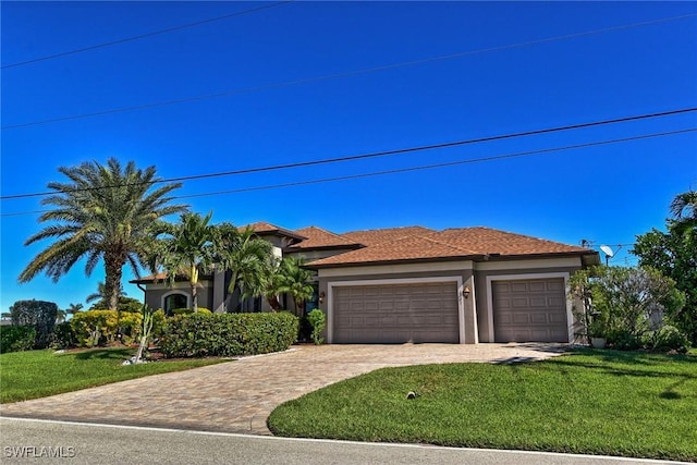 view of front of house with a garage and a front lawn