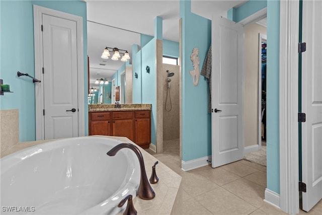 bathroom with tile patterned floors, vanity, and plus walk in shower