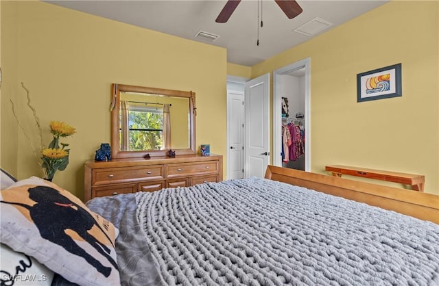 bedroom with ceiling fan, a closet, and a spacious closet