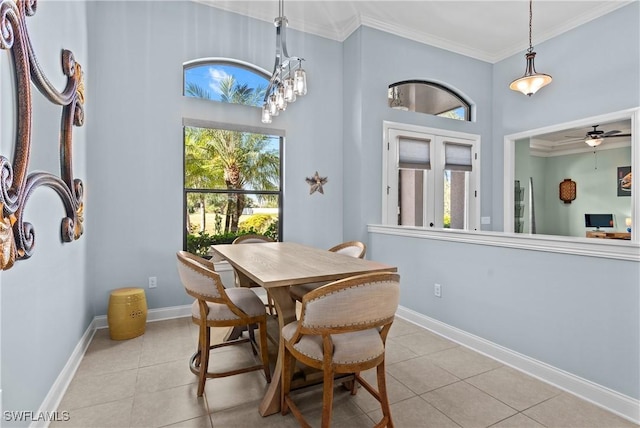 dining area featuring ceiling fan, ornamental molding, and light tile patterned floors