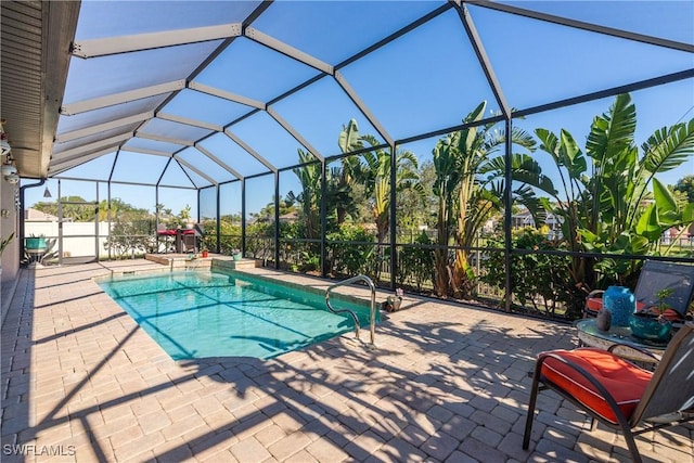 view of swimming pool featuring a lanai and a patio area