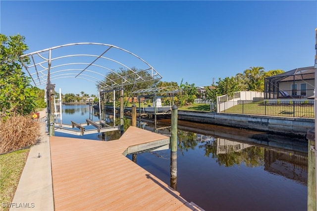 view of dock with a water view and glass enclosure