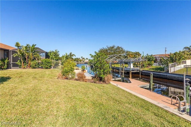 view of yard featuring a water view and a boat dock