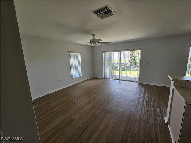 unfurnished room featuring ceiling fan and dark wood-type flooring