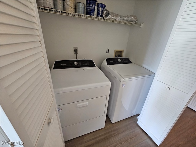 washroom featuring separate washer and dryer and dark hardwood / wood-style floors