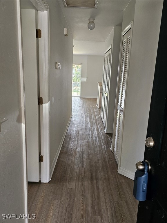 hallway with dark hardwood / wood-style floors