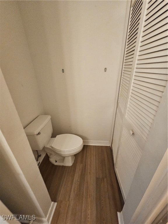 bathroom with toilet and wood-type flooring