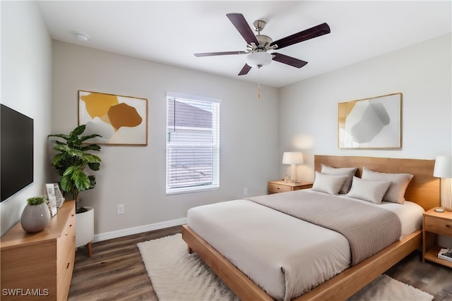 bedroom with ceiling fan and dark wood-type flooring