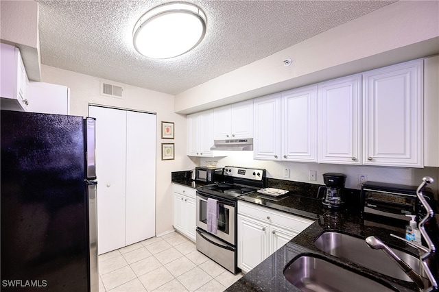 kitchen with electric stove, black refrigerator, white cabinets, and a textured ceiling