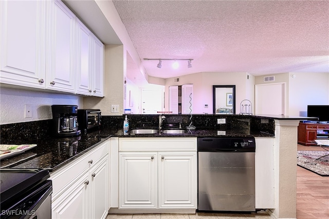 kitchen with white cabinetry, sink, stainless steel appliances, light hardwood / wood-style flooring, and a textured ceiling