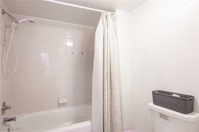 bathroom featuring shower / bath combo with shower curtain and toilet