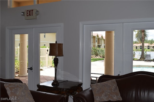 entryway featuring french doors, light tile patterned floors, and a healthy amount of sunlight