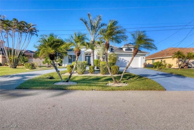 view of front of house featuring a garage and a front lawn