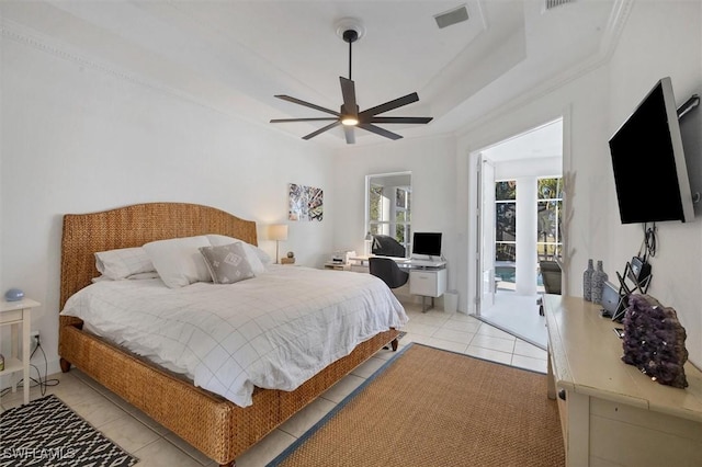 bedroom featuring ceiling fan, access to exterior, light tile patterned floors, and a raised ceiling