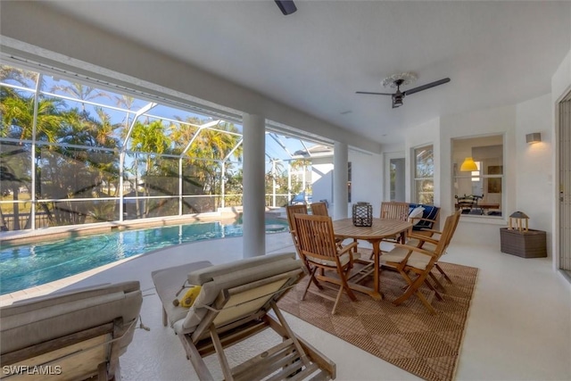 sunroom / solarium featuring a swimming pool and ceiling fan