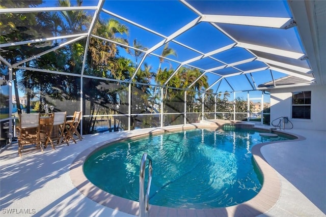 view of swimming pool featuring a lanai and a patio