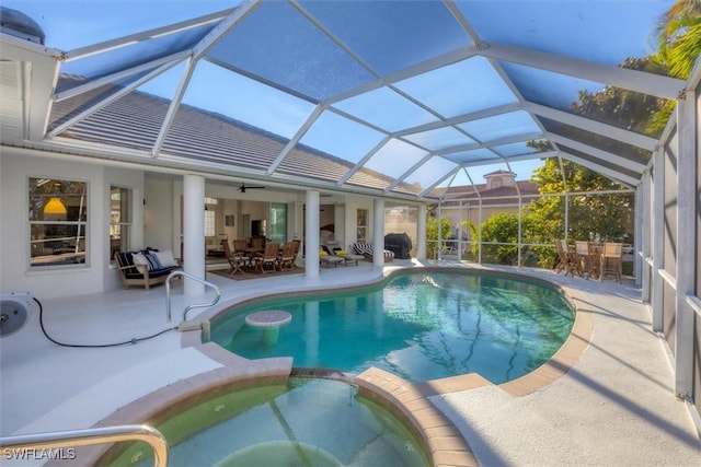 view of swimming pool featuring a patio area, a pool with connected hot tub, and outdoor dining area