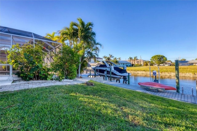 dock area with glass enclosure, a water view, and a lawn