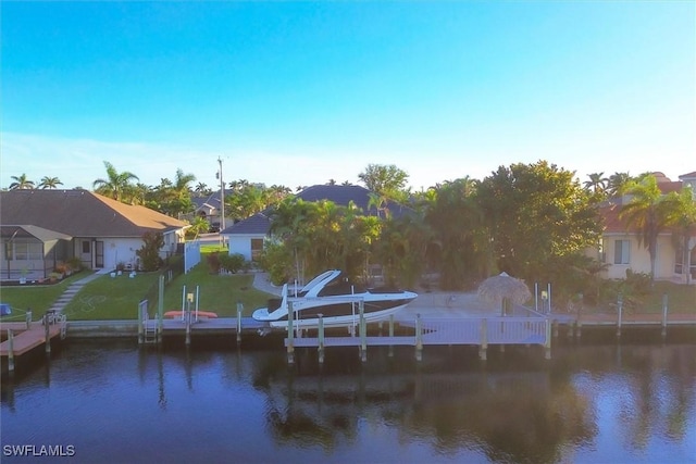 dock area with a water view and a yard