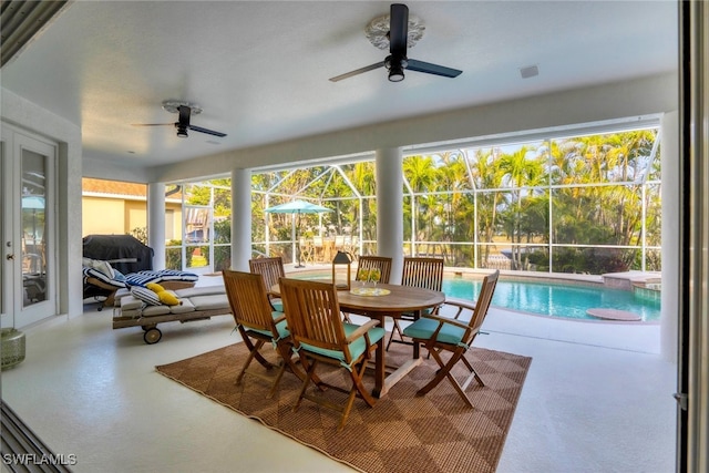 sunroom / solarium with ceiling fan and a pool