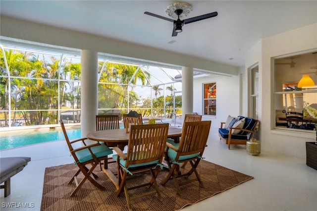 sunroom / solarium featuring ceiling fan