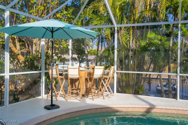 view of pool with a patio and glass enclosure