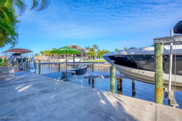 dock area with a water view and boat lift