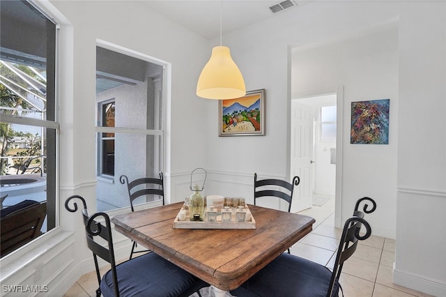 dining room with light tile patterned floors and visible vents