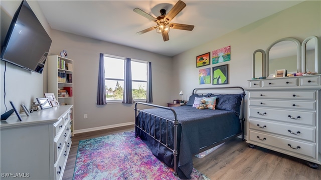 bedroom featuring ceiling fan and dark hardwood / wood-style floors