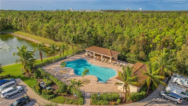 view of swimming pool with a patio area and a water view