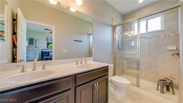 bathroom featuring tile patterned floors, vanity, toilet, and walk in shower