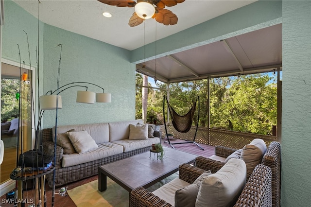 sunroom / solarium featuring ceiling fan