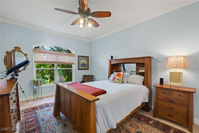 bedroom with light hardwood / wood-style flooring, ceiling fan, and crown molding