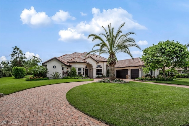 mediterranean / spanish house with a front lawn and a garage