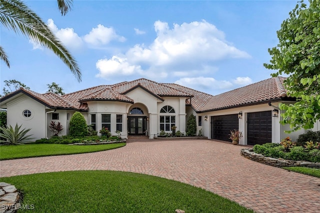 mediterranean / spanish-style house featuring french doors and a garage