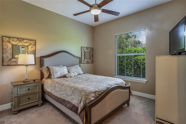 bedroom featuring light carpet and ceiling fan