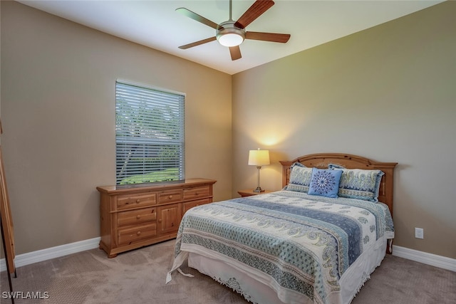 bedroom featuring ceiling fan and light carpet