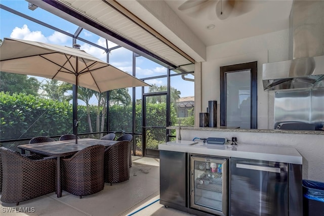 view of patio featuring a lanai, wine cooler, ceiling fan, and exterior bar