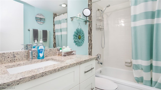 full bathroom featuring shower / bath combo, vanity, and toilet