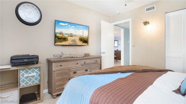 bedroom with light carpet and a closet