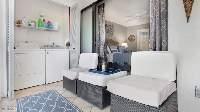 washroom with washing machine and dryer, ceiling fan, and light tile patterned floors