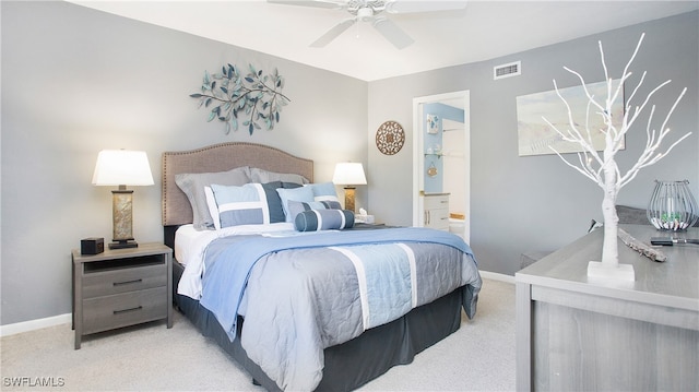 bedroom featuring connected bathroom, light colored carpet, and ceiling fan