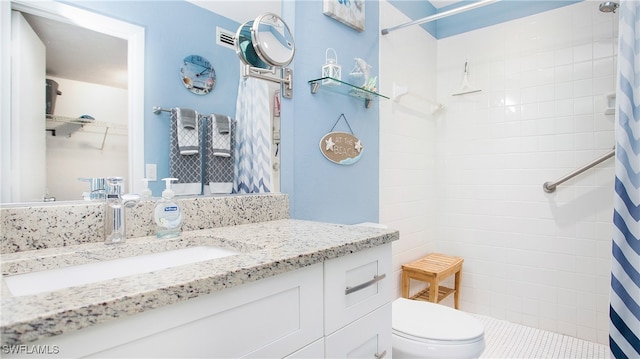 bathroom with tile patterned flooring, vanity, curtained shower, and toilet