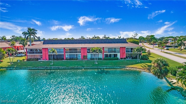 view of swimming pool featuring a lawn and a water view