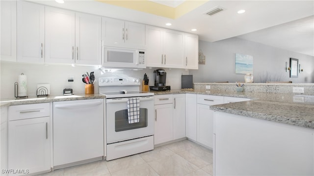 kitchen featuring backsplash, white cabinetry, light stone counters, and white appliances