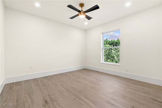 empty room with ceiling fan and light hardwood / wood-style floors