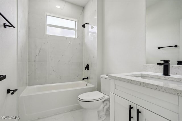 full bathroom featuring vanity, tiled shower / bath combo, and toilet