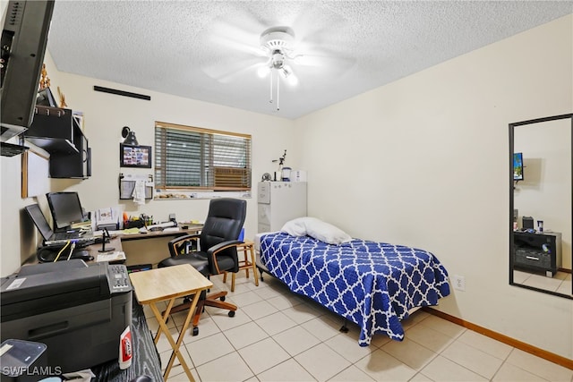 tiled bedroom featuring ceiling fan and a textured ceiling